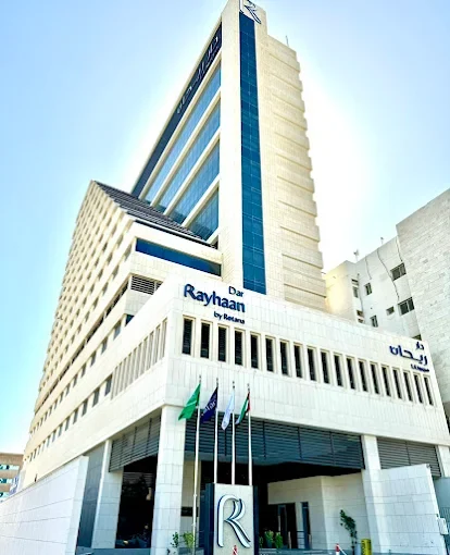 The entrance of Dar Rayhaan by Rotana, with its flags and sign