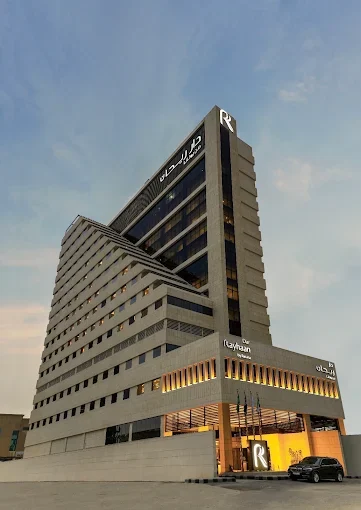The tower in the evening, its entrance lit